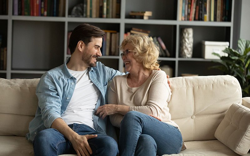 mom and son on couch, laughing